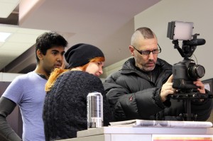 Local filmmakers J.D. Oppen (right), Swjetlana Oppen and Brian Khan look over footage from an earlier scene for their film submission Oct. 19.  The 48-Hour FlickFest required teams to write, shoot and edit a film in two days across the region as part of the Windsor International Film Festival.  (Photo by/Justin Prince)