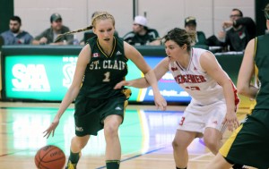 St. Clair College’s Kelly Rizea (left) runs by Redeemer University-College’s Arica Price during a regular season game at St. Clair College Nov. 2.  (Photo by/Justin Prince)