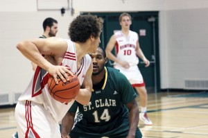 Redeemer University-College’s Calvin Turnbull (left) is guarded by St. Clair College’s Jamaal Thompson during a regular season game at St. Clair College Nov. 2.  (Photo by/Justin Prince)