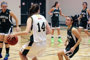St. Clair College Saints starter Shannon Kennedy (front-middle) attempts a spin move on Lambton College Lions guard Brittany Lewis (front-right) during a regular season game Nov. 8 at St. Clair College. (Photo by/Justin Prince)
