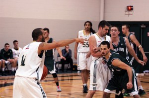 St. Clair College Saints forward David Youman (centre) attempts to make a shot while being triple-teamed by Lambton College’s Andy Timmermans (left), Shawn Hill and Alex Garvey during a regular season game Nov. 8 at St. Clair College.  (Photo by/Justin Prince)
