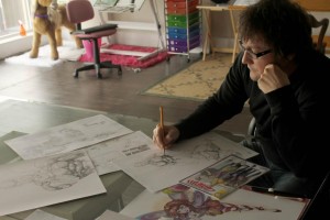 Tony Gray, co-owner of Glass Monkey Studios, working on “The Incredible Conduit” art at his Windsor studio Nov. 8. (Photo by Chris Mailloux)