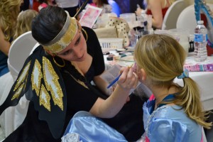 Kelly Spinarsky, a local cosmetologist, applies make-up to a little girl at a fundraising event in support of Cystic Fibrosis at the Fogolar Furlan Club in Windsor, Jan. 18. (PHOTO by Bobby-Jo Keats)