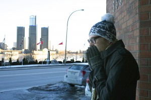 Marcell Pieniadz tries to warm up outside of the St. Clair Centre for the Arts, Feb. 28. (Photo by Casandra Malynowskyj)