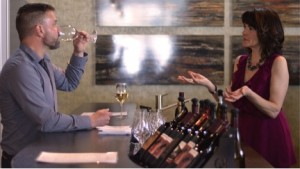 MaryAnn Perry, sales and events manager for Cooper’s Hawk Vineyard, conducts a wine tasting for make-up artist Michael Reid at CHV’s GlamaRama in Harrow, Feb. 22. (photo by/Richard Riosa)