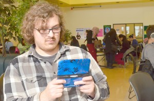 Windsor Pokemon X and Y group creator, Emerson Perkins, plays his limited edition Pokemon Nintendo 3DS at St. Clair College  Feb. 21. Perkins has organized a competitive tournament for Nintendo’s Pokemon video game series.