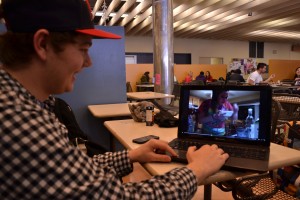 University of Windsor  student Stewart McLellan watches a Neknominate video of a teen eating cereal with vodka at the CAW Student Centre in Windsor.
