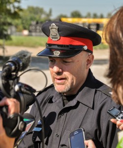 Sgt. Matthew D'Asti speaks to the media outside Canadian Electric Coating on Sept. 19, where a 55-year-old-woman has died.