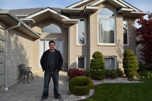 Dave Antovski, 42, standing in front of his recently sold residence in south Windsor, Ont., on Monday Oct. 27. (Photo by  Johnathan Hutton)