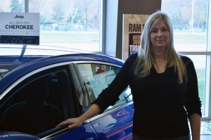 Shelley Shanahan, a sales consultant at Provincial Chrysler Ltd. In front of her favorite car,  the Chrysler 200.