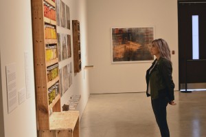 Triennial coordinator Jude Abu Zaineh admires an artist's work displayed in the Art Gallery of Windsor on Nov. 7 (Photo by Ryan Adams)