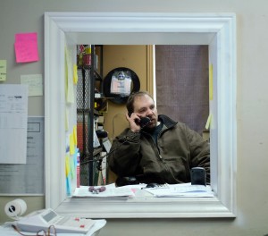 Kevin Awram speaks to customers on the phone at Windsor Truck Maintenance in Windsor on Jan. 27.  Awram discussed taxes and the effect on him as a homeowner. (Photo by: Ashley Ann Mentley)