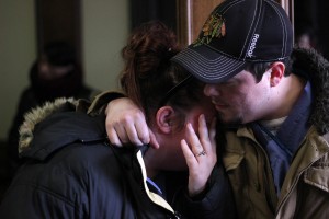 Bobby Knight (right), a 25-year-old personal support worker student at Everest College, hugs his classmate Amanda Hunter, 27, after finding out about the closure of the college at their campus on Ouellette Avenue in Windsor Feb. 19. (The Converged Citizen Photo by / Justin Prince)