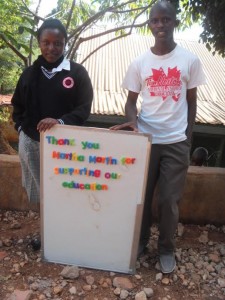 Photo courtesy of the Greater Essex County District School Board Faith Mwikali Muthenya (left) and Eric Ngila (right) pose for a photo in Kenya, Africa. The sign they are holding is to thank Martha Martin and LaSalle Public School for the funds to pay their school tuition.