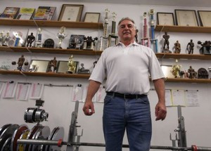Many people around the Windsor/ Essex County region believe Jerry Marentette,59, is the greatest powerlifter from Canada. He holds up a weight at his gym Power Pit April, 1, 2015. Photo-By Shaun Garrity.