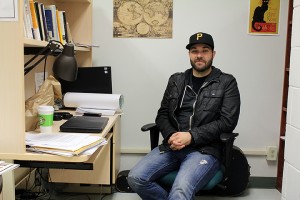 Travis Reitsma, 31, sits at his desk at the University of Windsor. Reitsma is working towards his PhD in sociology and has $100,000 of student debt that the doesn't not expect to pay off.