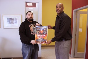 (WINDSOR, Ont. (25/10/15) : Windsor Express marketing and group sales manager Houssain El-Kadri (left) and head coach Bill Jones (right) holds an exhibition game flyer at the Downtown Windsor Business Accelerator in Windsor, Ont. on Thursday, Oct. 29,2015. The Windsor Express will host an exhibition game against the NBA Development League team -the Raptors 905- on Nov. 5. Photo by Aaron Sanders. 