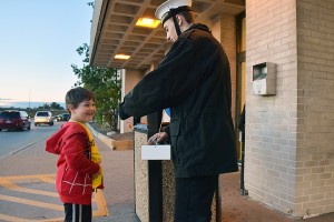 Andre Doucharme (right) receives donations from a child (left) while tagging at Devonshire mall on October 16, 2015. (Photo by Johnathan Hutton) 