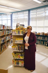 Martha Martin poses for a photo in the library at LaSalle Public School, on Oct. 8. Martin has been a librarian for over 20 years and is also an author and reader of YA novels.