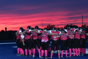 Tecumseh Vista football team huddles before their game against Riverside Secondary School at Tecumseh Vista Academy on Friday, October 2, 2015
