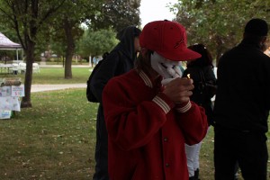 A masked man lights a joint during the culture festival in David Croll Park on Oct. 3 2015 (photo by Samantha Girardin)