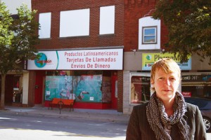 LEAMINGTON, ON OCTOBER 1, 2015---Camille Thompson, a bartender at Bedrocks, a bar on 29 Erie Street South stands outside several stores geared towards migrant workers across the road.