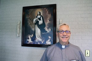 WINDSOR, ON SEPTEMBER 29, 2015---Maurice Restivo, pastor at Assumption Catholic Parish, poses beside a picture of the Virgin Mary at his office on 350 Huron Church Road on September 28, 2015. PHOTO BY/DAVID DYCK