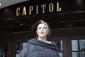 Shelly Sharpe, the manager of marketing, communications, and sales for the Windsor Symphony Orchestra poses in front of the Capitol Theatre (photo by Christian Dutchyn)