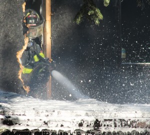 Windsor Ont. (10/17/15) – A windsor Firefighter extinquishes a blaze on Norman Rd. on Saturday, Oct. 17, 2015. The blaze was attributed to an electical fault, the only fatality was the family cat. Photo By Dan Gray, The Converged Citizen.