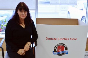Joyce Montrose sits next to clothing donation bin at the Canadian Diabetes Association on Howard avenue in Windsor on Nov. 13. Donated clothing goes to Value Village. (photo by Josh Chemello) 