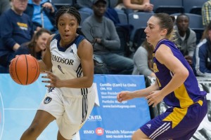 Lancer point-guard Tyra Blizzard, left, dribbles past a Laurier player Nov. 4 at the St. Denis Centre