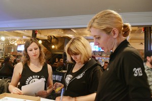 WINDSOR, ON -- (Left to right) Maura Coughlin, Shawna Tooke and Jaime Guthire discuss the Fresh Meat sign-ups at the Foundry pub on Nov. 17. The Border City Brawlers set up sign ups for new players, refs and volunteers. 
