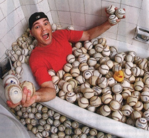 Zack Hample lays in his collection of baseballs. Hample has caught 8,633 baseballs in his lifetime. (Photo courtesy of @zack_hample)