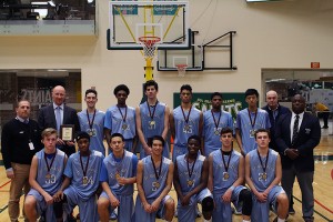 The Toronto St. Michael's boys basketball team poses with their gold medals after winning their sixth consecutive Freeds Tip Off tournament championship