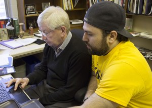 WINDSOR, Ont. (11/12/15) – Former Windsor-Tecumseh MP Joe Comartin (left) and political science student Ronnie Haidar (right) prepare the research Comartin plans to use in his January 2016 seminar in his University of Windsor ffice on Friday, Dec. 11, 2015. organize at the University of Windsor on Friday, Dec. 11, 2015. Photo by Shelbey Hernandez, Media Convergence.