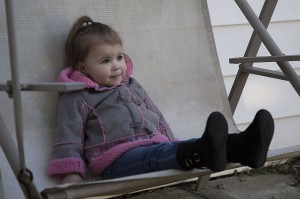 WINDSOR, Ont. (15/11/15) - Sasha LePage sits on a rocking chair in the backyard of her home on Bernard Road in east Windsor on Sunday, November 15, 2015. LePage later played with her mother Merisa and father Joseph in the yard. LePage has Cystic Fibrosis. Play is a part of her daily routine, which also includes physiotherapy and being given medication. Photo by Sean Previl, The Converged Citizen.