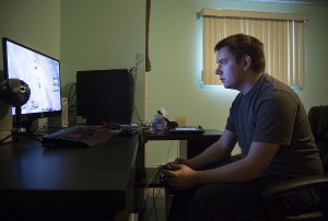 WINDSOR, Ont. (18/11/15) – Daniel Banner is pictured playing Super Smash Bros Wii U in his bedroom and gaming room at his house in McGregor on Wednesday, Nov. 18, 2015. Banner, who moved to McGregor from Windsor about two years ago, has designed his gaming setup to look similar to what most eSports tournaments use. Banner sets aside at least one hour each day to practice the game. He also plays in tournaments on a weekly basis at the Kappa Gaming Lounge, owned by Windsor-based company eSport Gaming Events. Photo by Justin Prince, The Converged Citizen