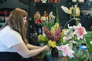 WINDSOR, ON -- Victoria's Flowers owner Kathy Molenaar prepares a bouquet of orchids for a customer. A bouquet like this can range into the hundreds of dollars. 