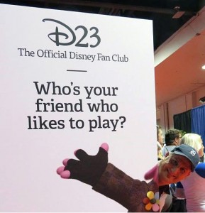 Local Disney enthusiast Brian Delisle peeks from behind a Disney Fan Club sign at the D23 Expo in Burbank, CA. 