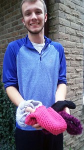 Matthew Rac-Sabo donating hats and mittens to the Tie One One campaign. Photo by Chelsea Girard