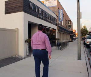 A young man looking at Wineology’s first location on Wyandotte Street East. Photo by Kylie Turner