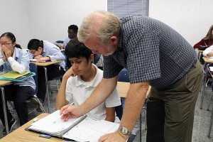Duke Culumovic teaches students math at Catholic Central High School (Photo by Vanessa Cuevas)