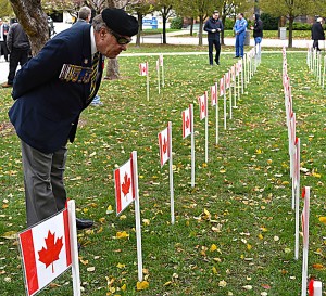 Veteran Mike Dupras reads the names of fallen Canadian Soldiers at City Hall Square. Photo by Alyssa Leonard