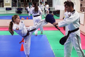 Stefena Dragiceuic (left) practices kicking with instructor Edgardo Dechavez (right) in the Masters Taekwondo Academy.