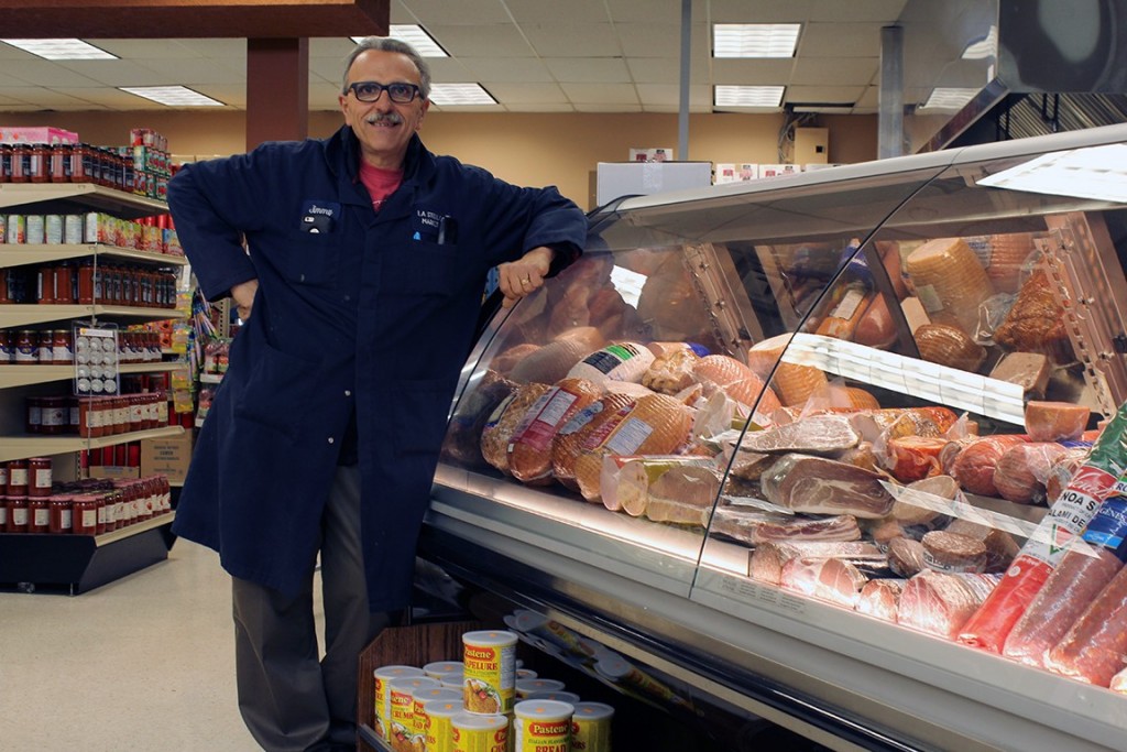 Eugene Pugliese stands in front of the meat display at La Stella Market. Photo by Amos Johnson 