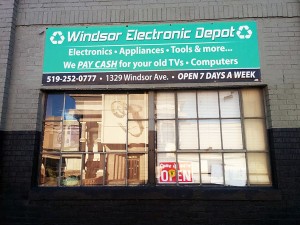 An open sign sits in the window of the Windsor Electronics Depot. (Photo by Barry Hazlehurst)