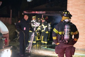 Firefighters work to extinguish a blaze in a garage on Leonard Rd. in east Windsor on Feb. 9 ( photo by Dan Gray ) 