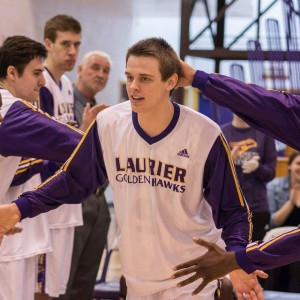 Former Laurier Golden Hawks forward Luke Allin high fives teammates during pregame announcements during his sophomore season before transferring to the University of Windsor later that season. (Photo courtesy of Luke Allin)