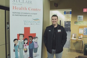 Marcus Harrison waits in front of the St. Clair College Health Centre at the Centre for the Arts in downtown Windsor (Photo by Amos Johnson).