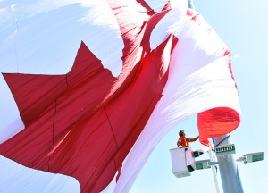  A crane operator is helping the giant Canadian flag be raised on the 45 metre poll situated in Dieppe Park at Ouellette Ave and Riverside Dr. on Saturday May 20. Photograph by Kati Panasiuk 